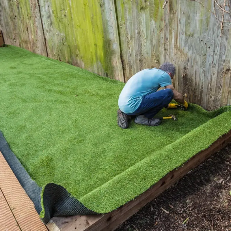 A luxury carpet professional installing a artificial grass carpet in Dubai