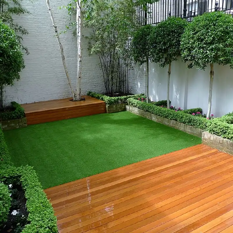 central patch of bright green artificial grass surrounded by wooden decking