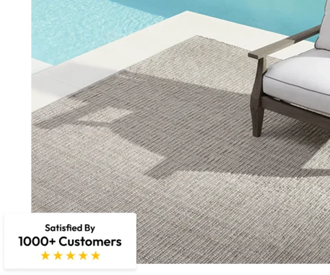 light gray outdoor carpet on a poolside patio next to a white chair
