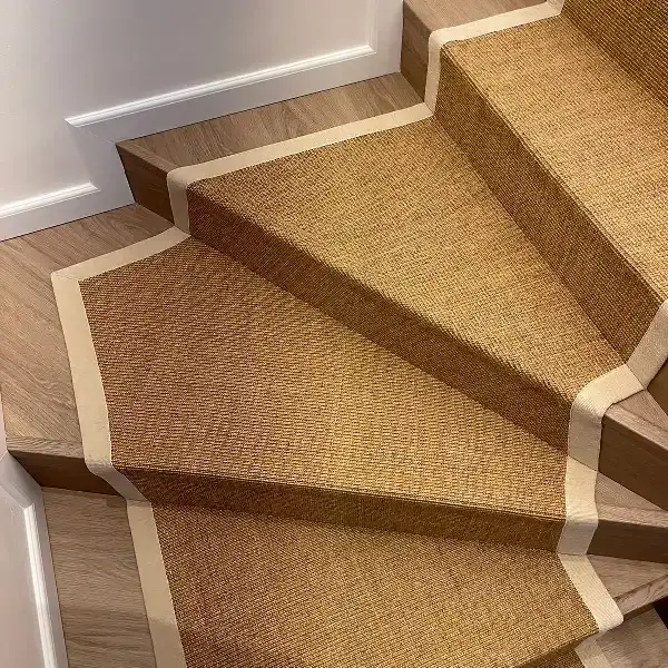 natural-fiber stair runner with a light-colored border.
