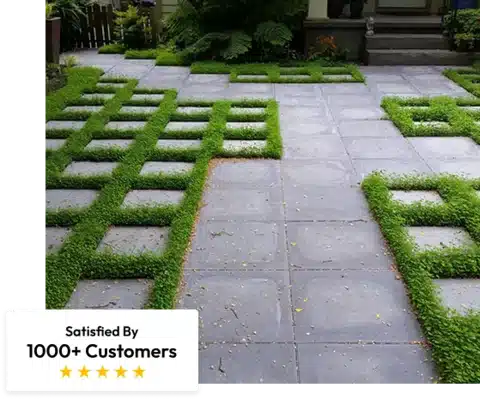 stone paver patio with gaps filled by bright green, dense groundcover or artificial turf