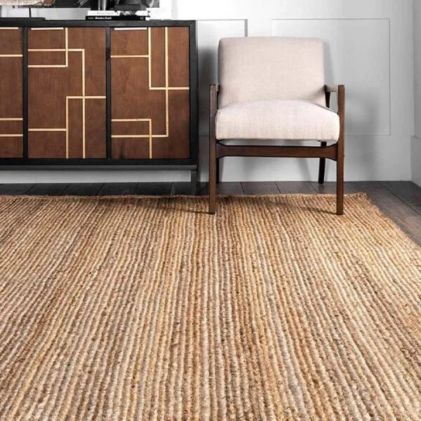 textured jute rug with vertical stripes in a living room.