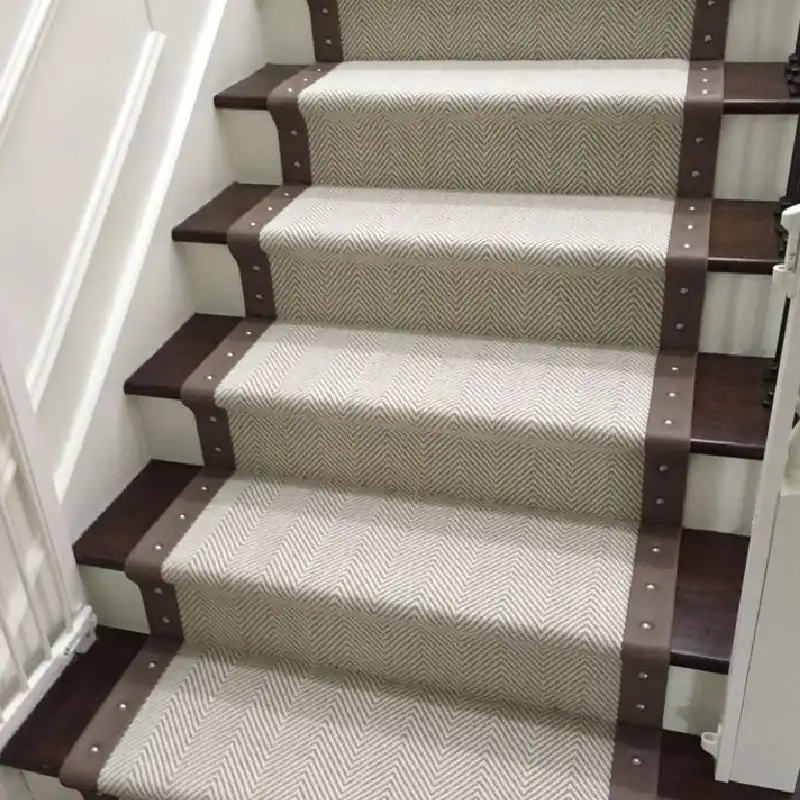 Herringbone patterned stair runner with contrasting brown carpet borders
